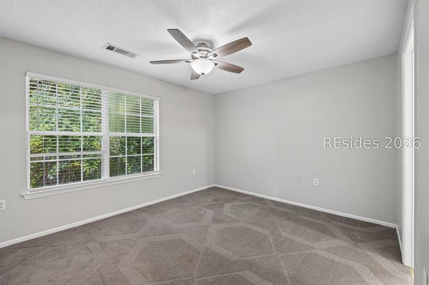 Enjoy wooded views from this second-floor condominium in The - photo 16