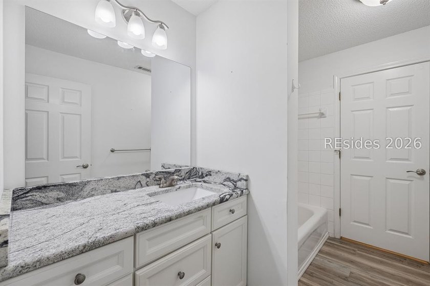 Enjoy wooded views from this second-floor condominium in The - photo 18