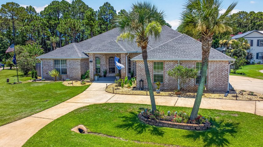Nestled on a .54 acre corner cul-de-sac lot in the gated - photo 3