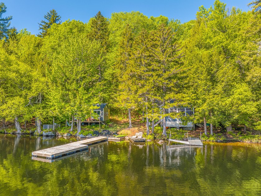 Set along approximately 150 feet of pristine shoreline on the - photo 4