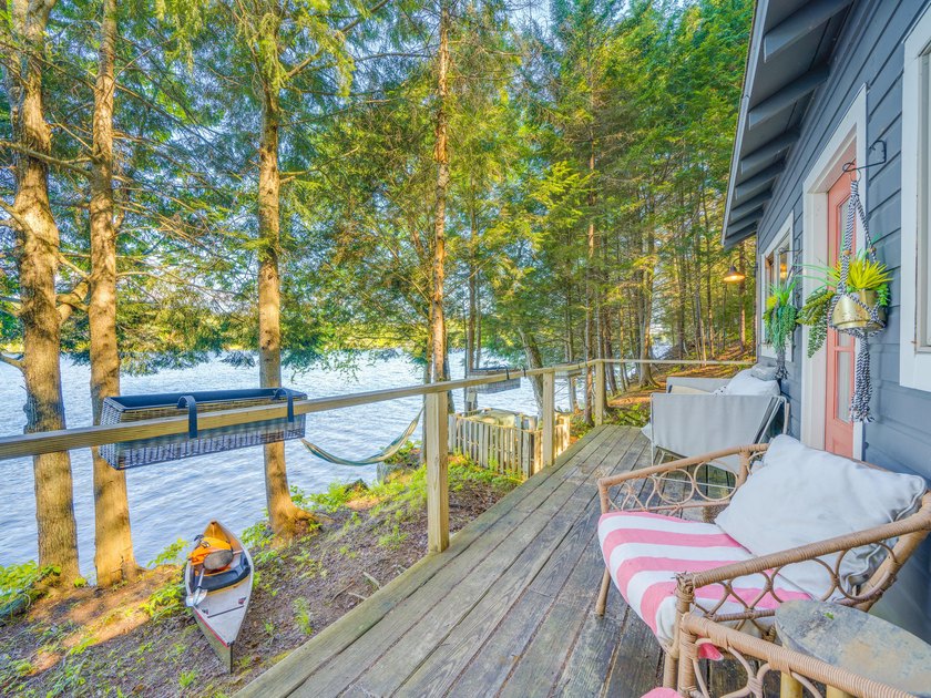 Set along approximately 150 feet of pristine shoreline on the - photo 6