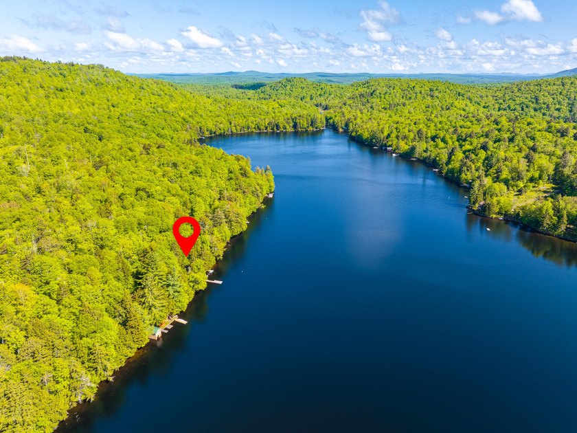 Set along approximately 150 feet of pristine shoreline on the - photo 7