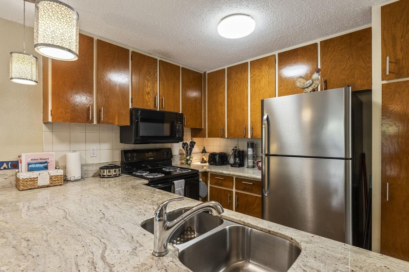 Welcome to Kihei Resort #105, a charming ground-floor condo in a - photo 5