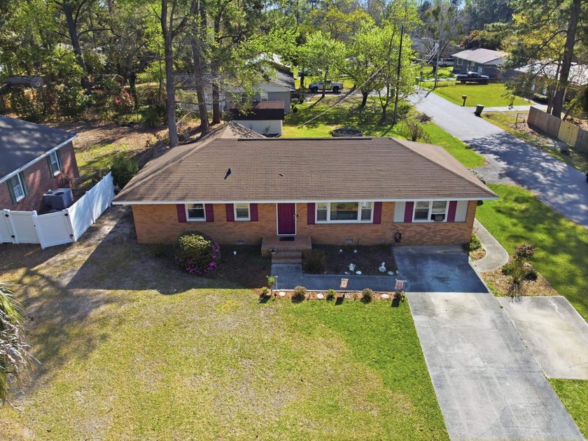 Charming 4-bedroom home situated on a spacious corner lot shaded - photo 2