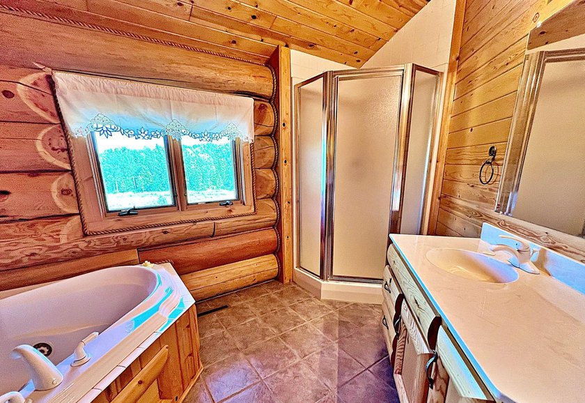 Authentic log cabin retreat on 80 picturesque acres featuring a - photo 28