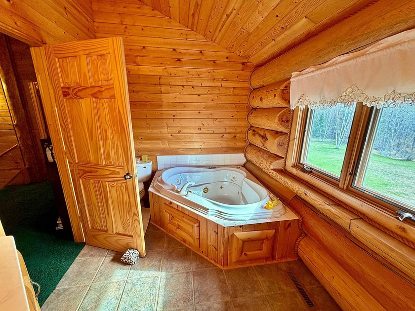 Authentic log cabin retreat on 80 picturesque acres featuring a - photo 30