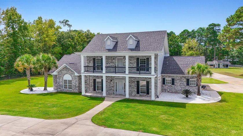 Exceptional all-brick estate set on 3.47 acres in a private - photo 3