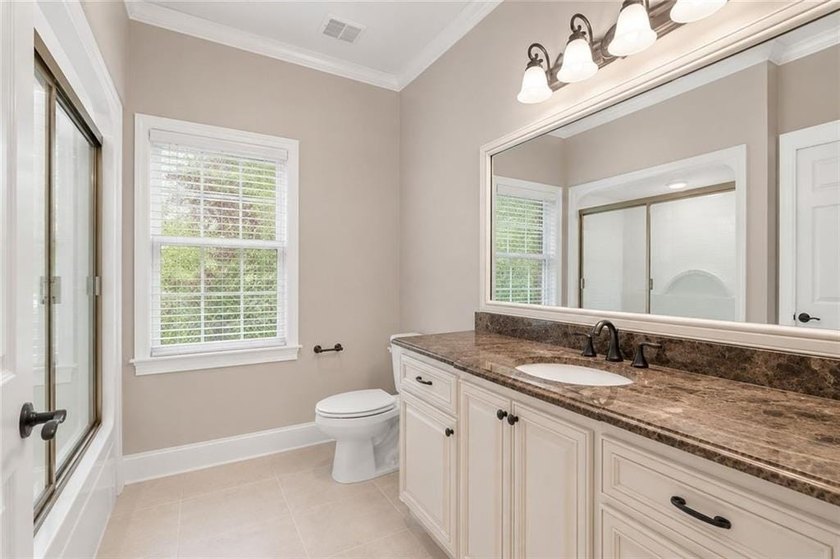 This exquisite four-sided blush brick estate is the epitome of - photo 16