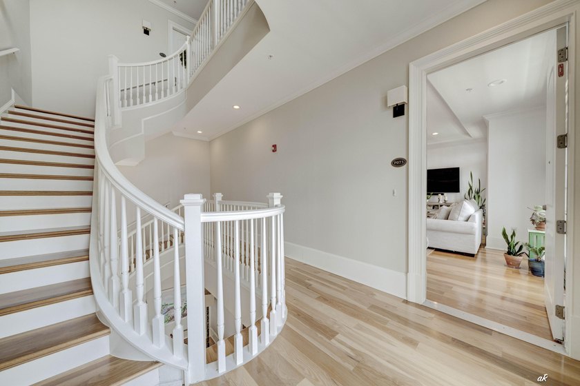 This extraordinary waterfront end unit condo, nestled in the - photo 3