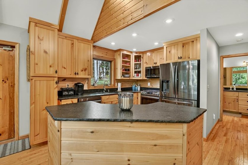 Tucked beneath a canopy of towering hardwoods and surrounded by - photo 11