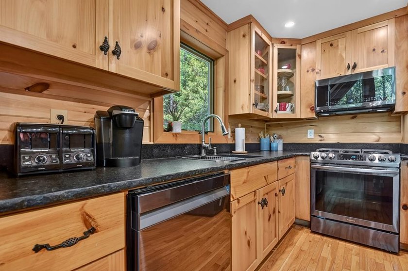 Tucked beneath a canopy of towering hardwoods and surrounded by - photo 12