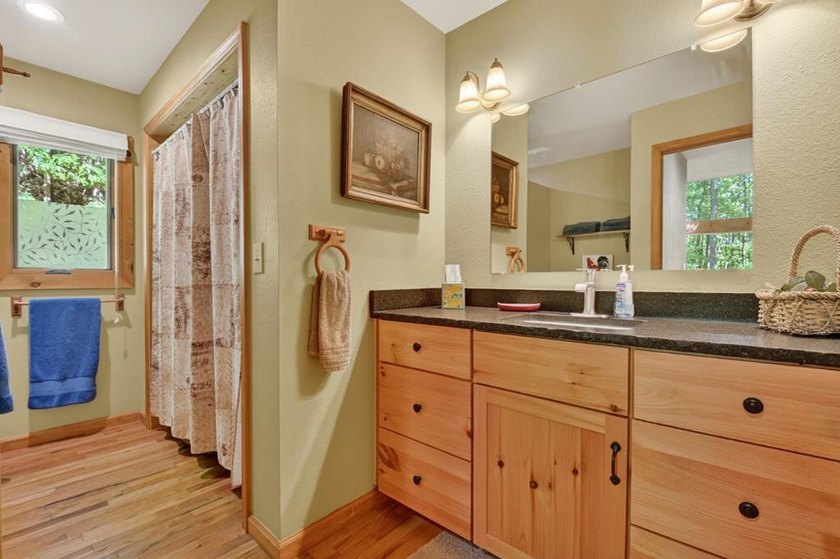 Tucked beneath a canopy of towering hardwoods and surrounded by - photo 17
