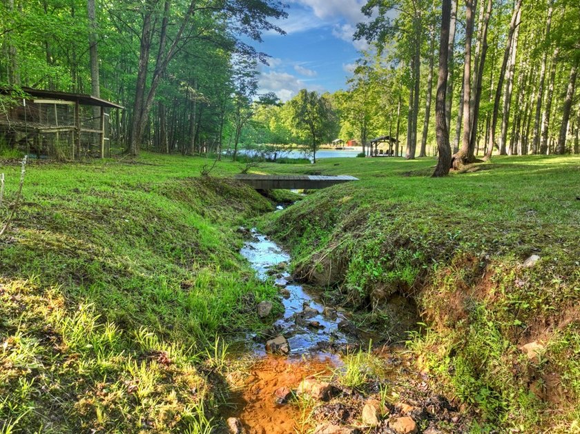 Tucked beneath a canopy of towering hardwoods and surrounded by - photo 25