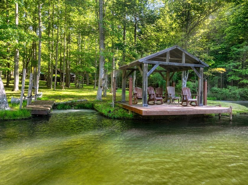 Tucked beneath a canopy of towering hardwoods and surrounded by - photo 26