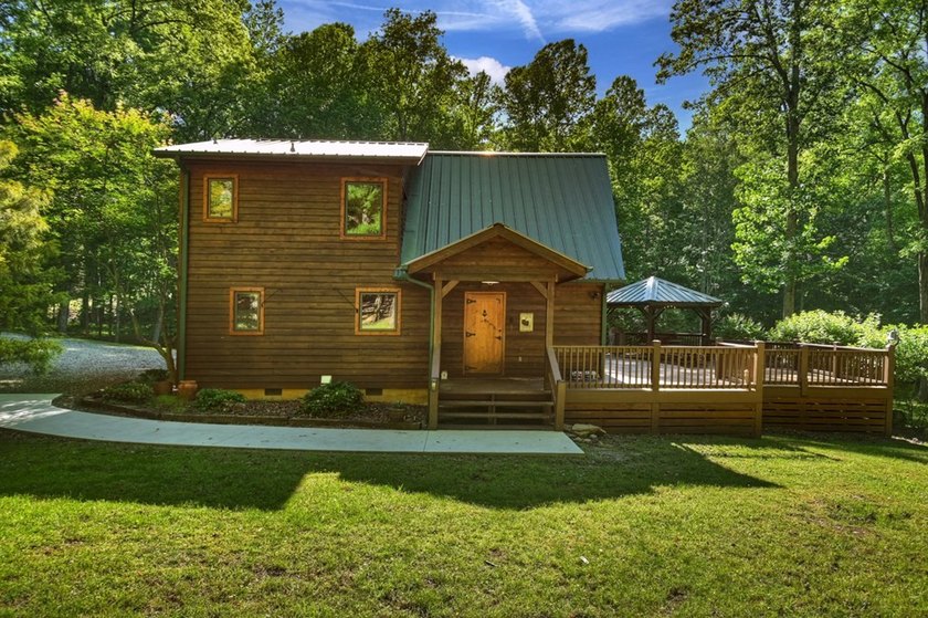 Tucked beneath a canopy of towering hardwoods and surrounded by - photo 29