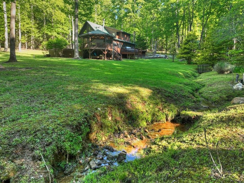 Tucked beneath a canopy of towering hardwoods and surrounded by - photo 48