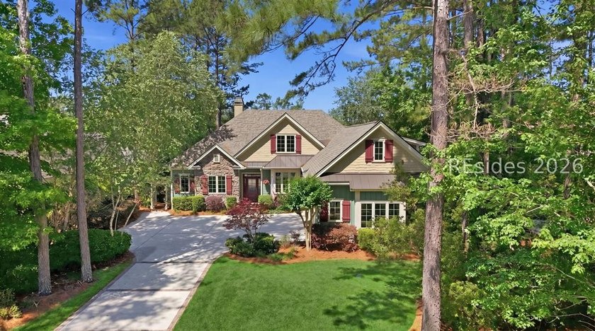 Tucked into a serene waterfront setting where towering trees - photo 2