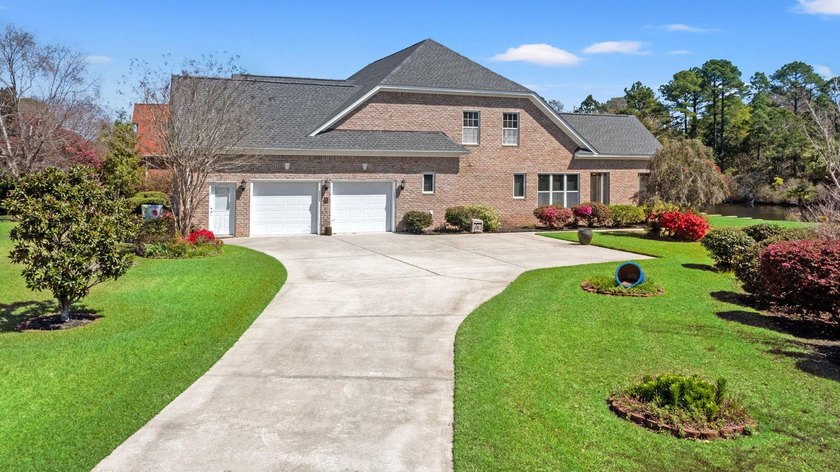 Nestled in a beautiful lakefront setting, this all-brick - photo 2