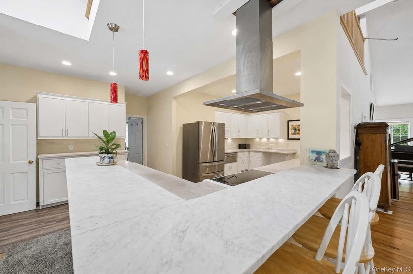 Set on a private 1.18-acre property in Hampton Bays, this - photo 15