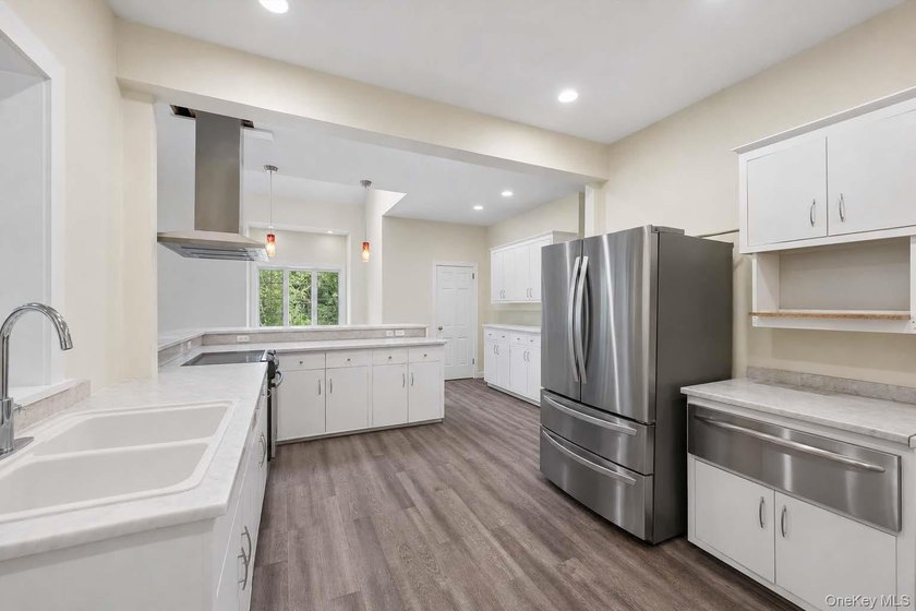 Set on a private 1.18-acre property in Hampton Bays, this - photo 16