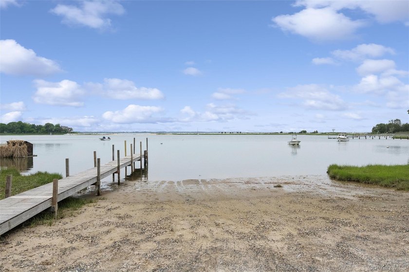 Set on a private 1.18-acre property in Hampton Bays, this - photo 32