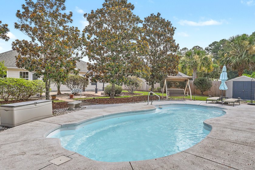 Nestled on a prime corner lot with serene pond views, this - photo 31