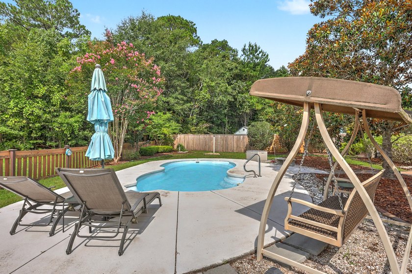 Nestled on a prime corner lot with serene pond views, this - photo 33