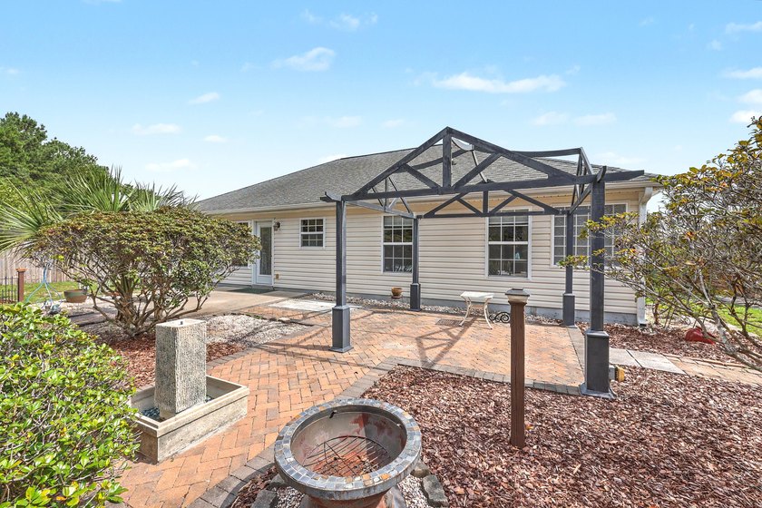 Nestled on a prime corner lot with serene pond views, this - photo 36