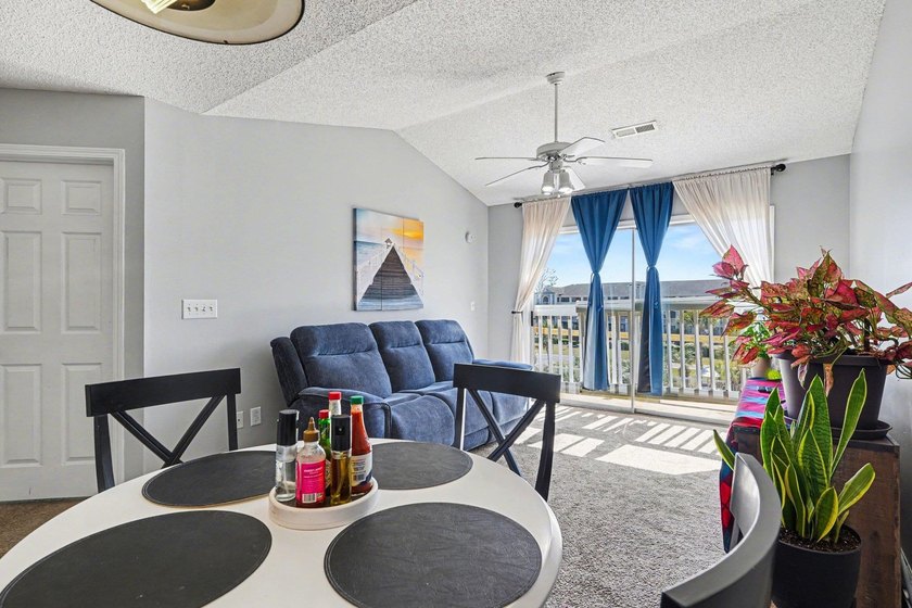 This 3-bedroom, 2-bathroom condo features a bright living room - photo 3