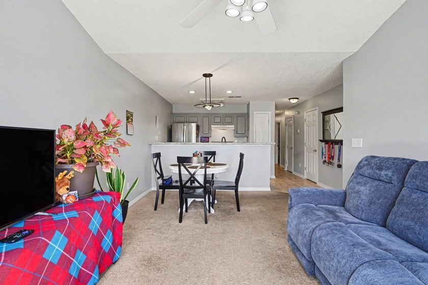 This 3-bedroom, 2-bathroom condo features a bright living room - photo 4