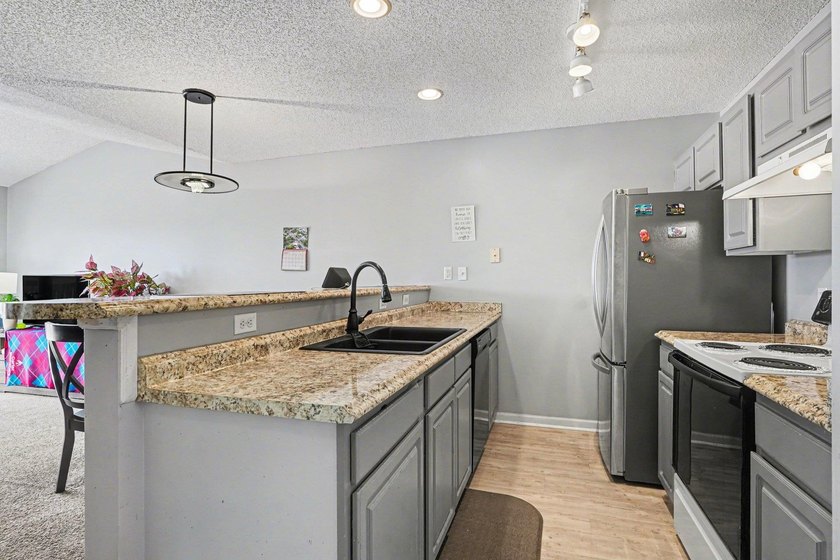 This 3-bedroom, 2-bathroom condo features a bright living room - photo 6