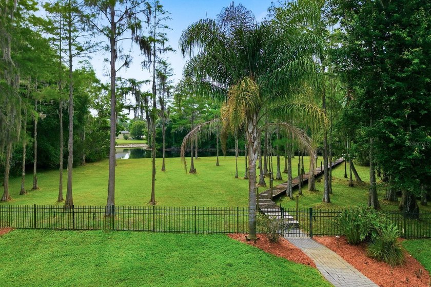 Privacy prevails on this custom home nestled on over an acre of - photo 3
