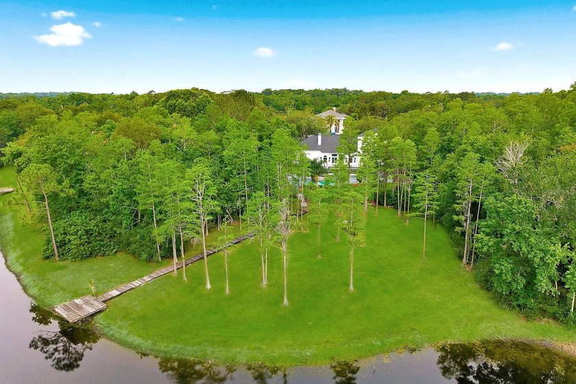 Privacy prevails on this custom home nestled on over an acre of - photo 4