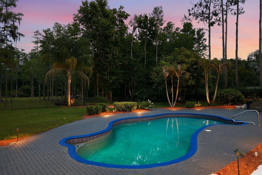 Privacy prevails on this custom home nestled on over an acre of - photo 7