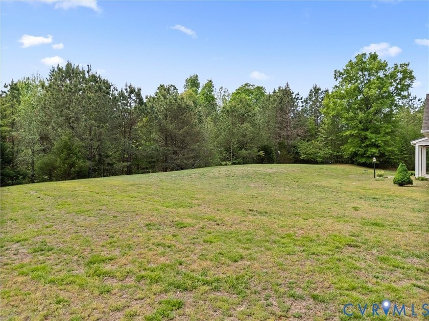 Custom-built and situated on 3.42 private wooded acres, this - photo 4