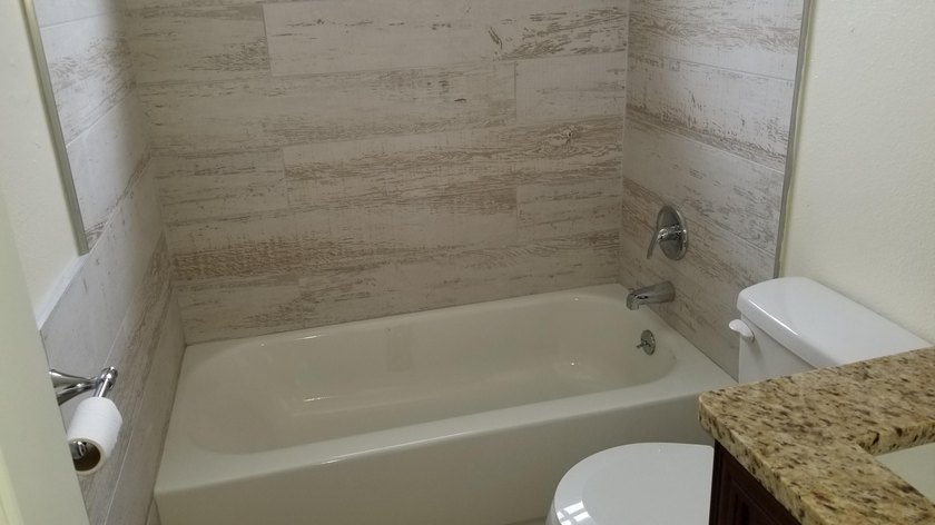 This updated ground floor unit features closed in porch; - photo 11