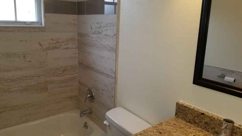 This updated ground floor unit features closed in porch; - photo 12