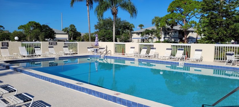 This updated ground floor unit features closed in porch; - photo 17