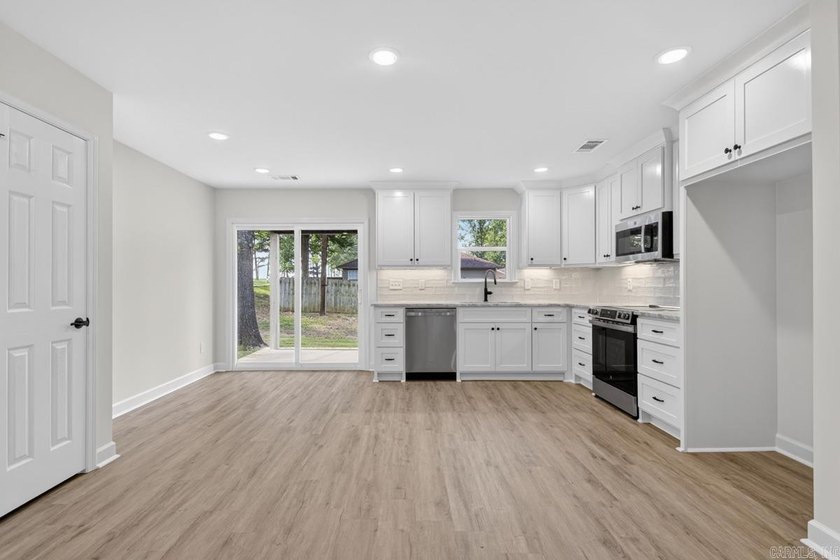 WOW! New Construction! Very pretty white siding w/white brick! - photo 6