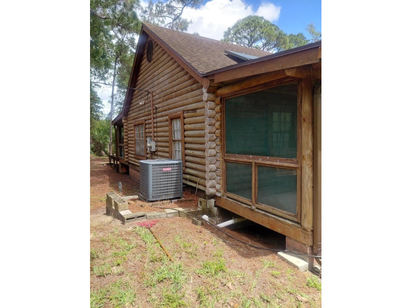 This 2-bedroom, 2-bathroom log cabin offers rustic charm. It is - photo 8