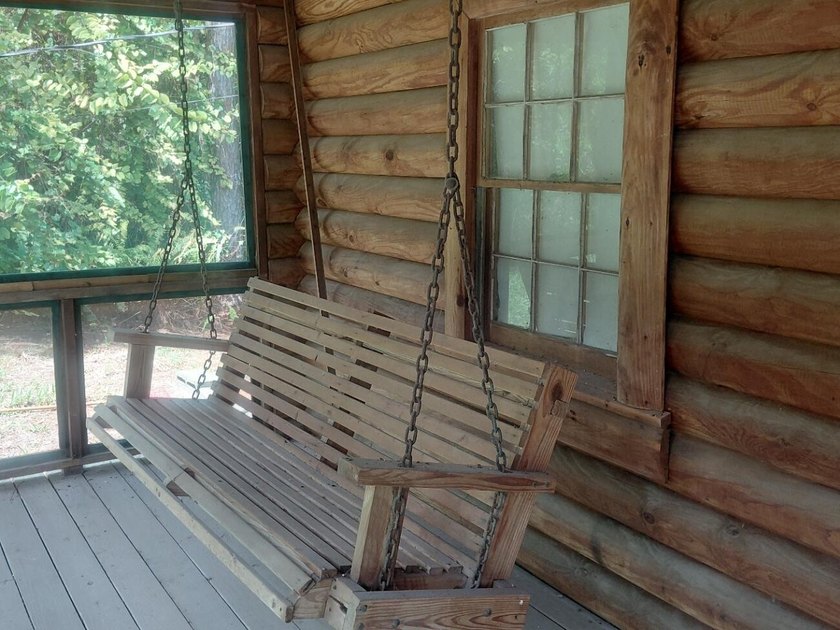 This 2-bedroom, 2-bathroom log cabin offers rustic charm. It is - photo 10
