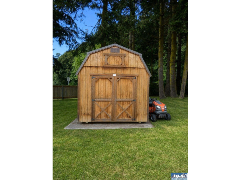 Tucked among mature trees and lovingly maintained, this inviting - photo 15