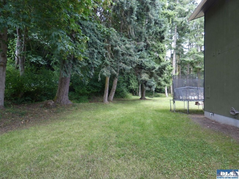 Tucked among mature trees and lovingly maintained, this inviting - photo 17