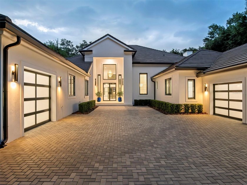 Set within the gates of renowned Isleworth, this beautifully - photo 2