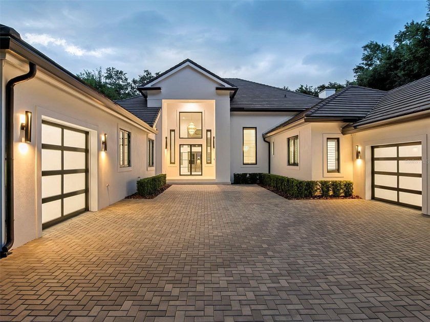 Set within the gates of renowned Isleworth, this beautifully - photo 3