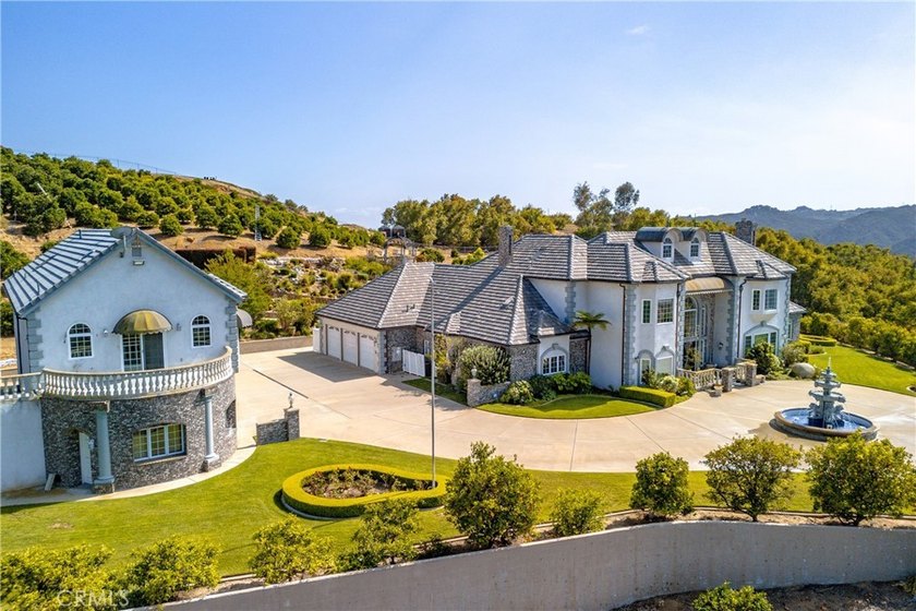 Positioned atop 20.22 fully fenced and gated acres, this stately - photo 6