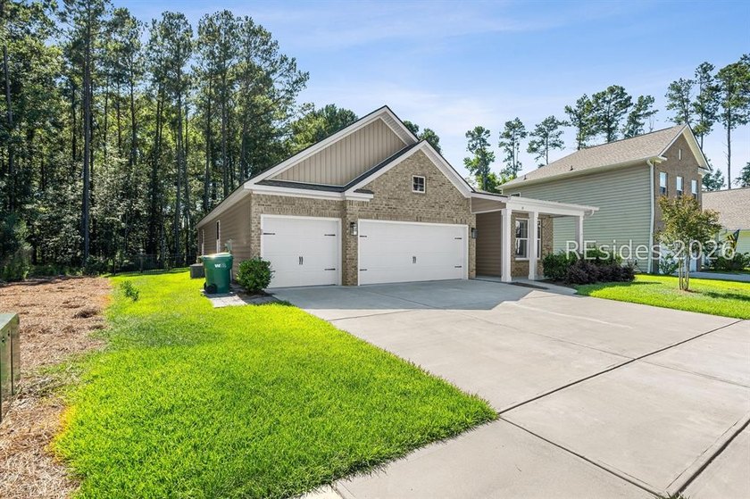 Tucked away on a private, wooded lot, this stunning single-story - photo 2