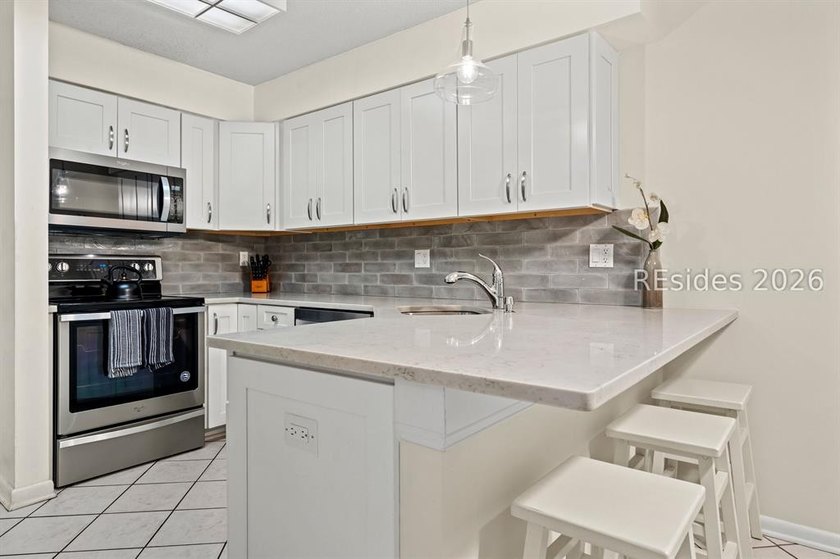 Tucked among mature landscaping in the highly desirable gated - photo 5