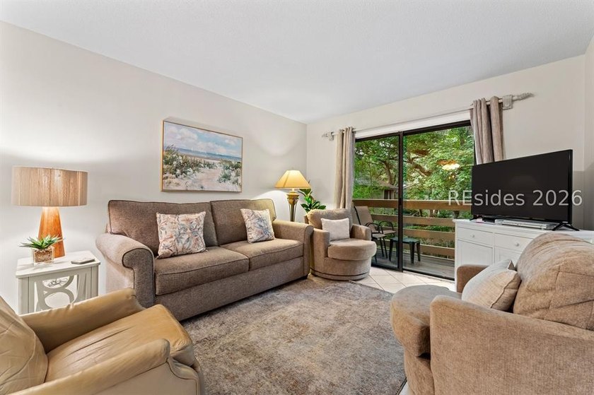 Tucked among mature landscaping in the highly desirable gated - photo 10