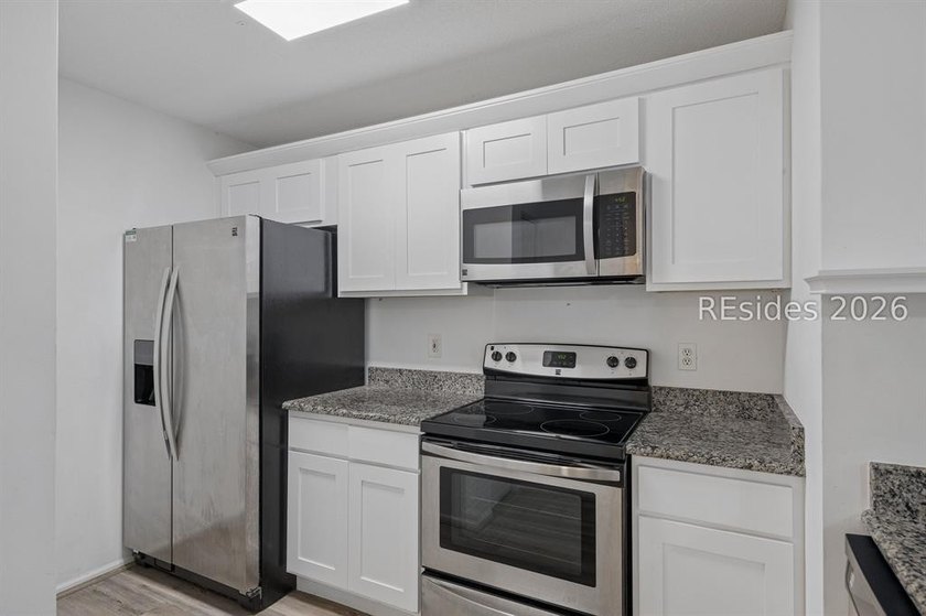 Enjoy wooded views from this second-floor condominium in The - photo 7